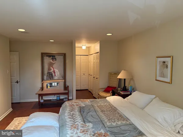 a bedroom with a bed and a lamp on table