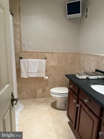 a bathroom with a sink a toilet and a shower