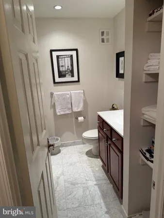 a bathroom with a toilet a sink a mirror and a shower