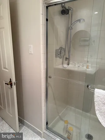 a bathroom with a glass shower door