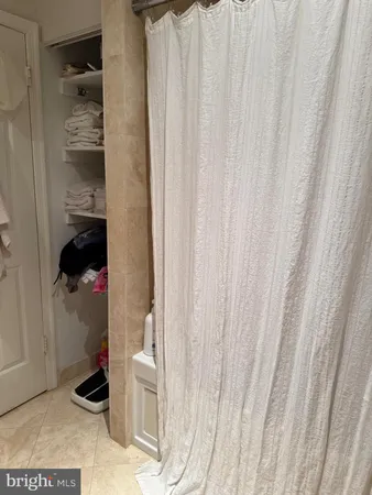 a bathroom with a toilet and a shower curtain