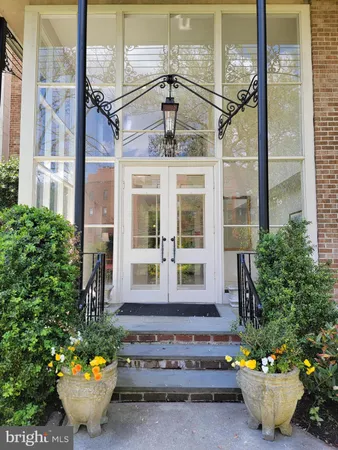 a front view of a house with potted plants