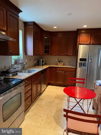 a kitchen with stainless steel appliances granite countertop a sink counter space and cabinets