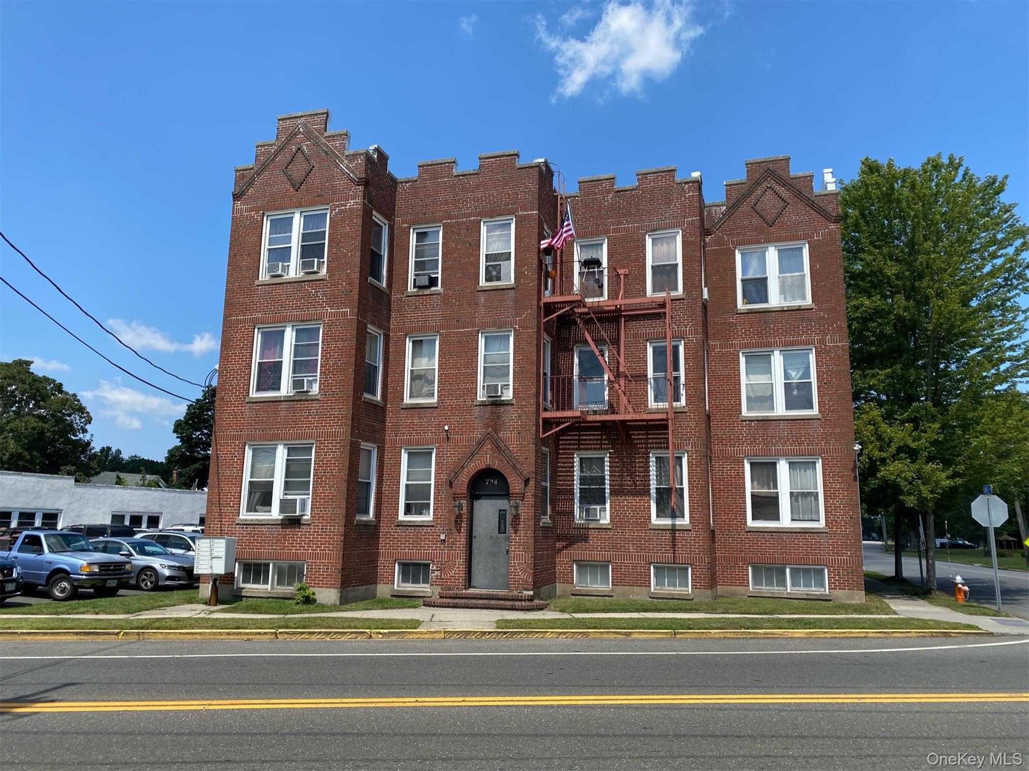726 Howell Avenue, Unit B Riverhead, NY 11901 - Photo 1 of 7 a view of building with a swimming pool