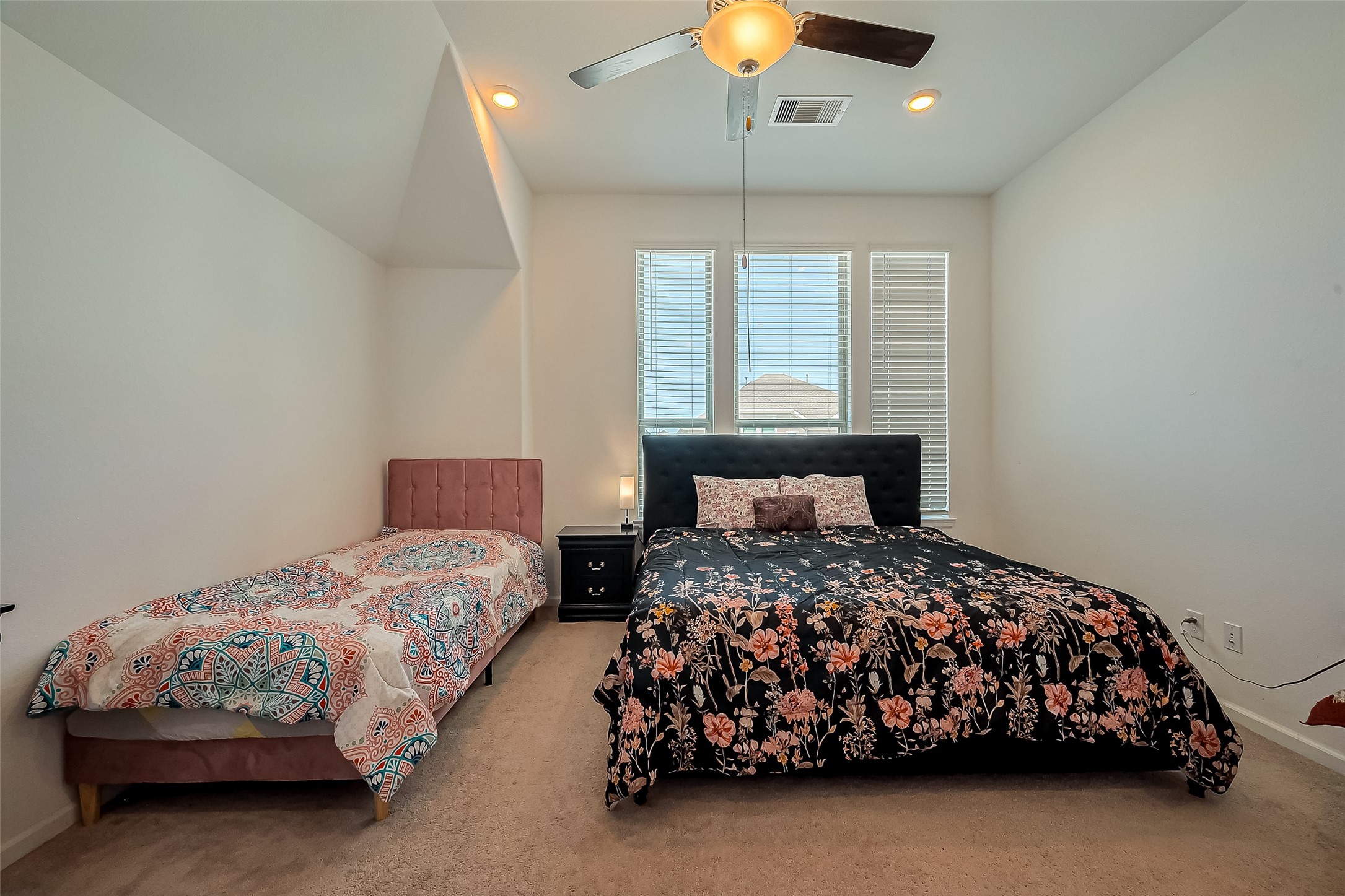 4134 Champlain Way Iowa Colony, TX 77583 - Photo 35 of 38 a bedroom with two beds lamp and a large window