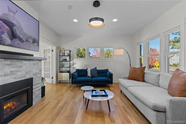 a living room with furniture and a fireplace