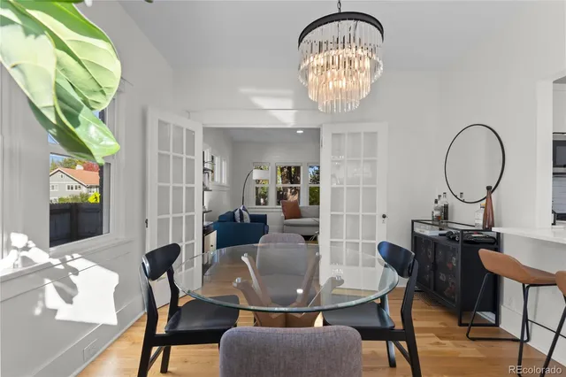 a view of a dining room with furniture a chandelier and wooden floor