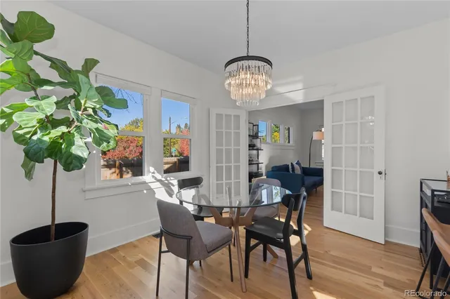 a view of a dining room with furniture wooden floor and chandelier