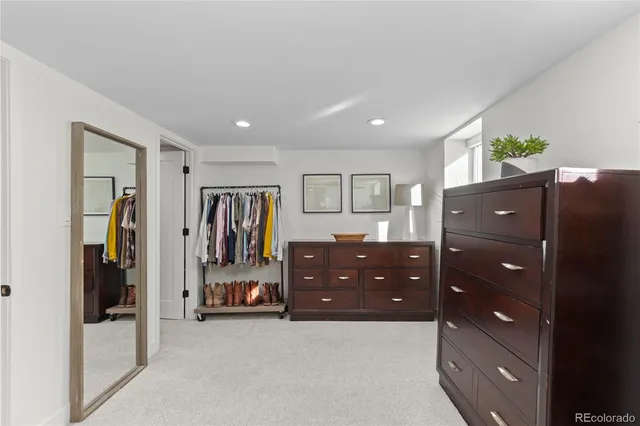 a room with a bed and a dresser