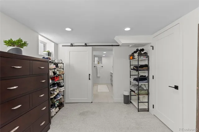 a view of walk in closet with clothes and shoes