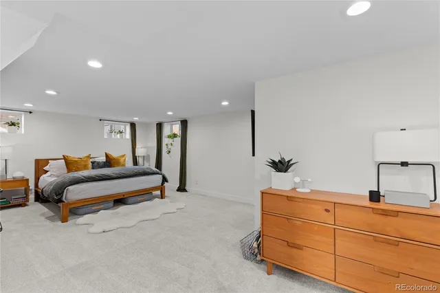 a bedroom with furniture and a mirror