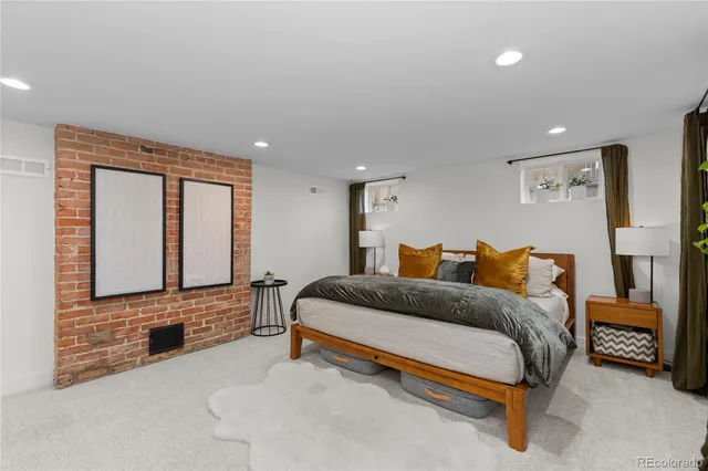 a spacious bedroom with a bed and a large mirror