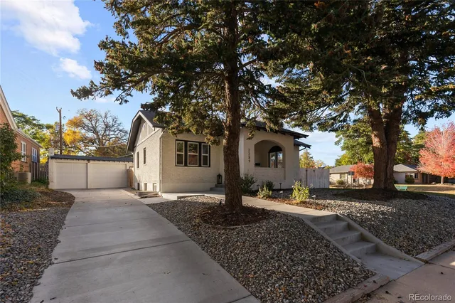 a large tree in front of a house