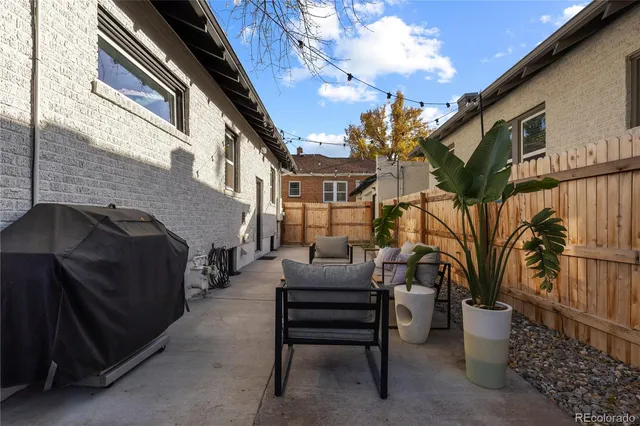 a view of a patio with couches and potted plants