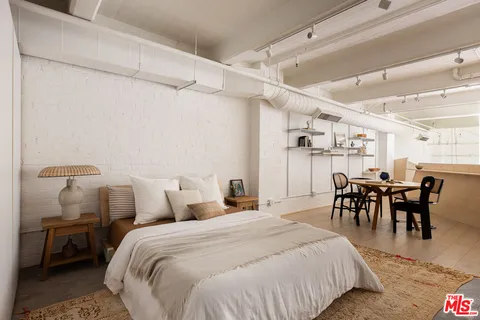 a bedroom with a bed and chair