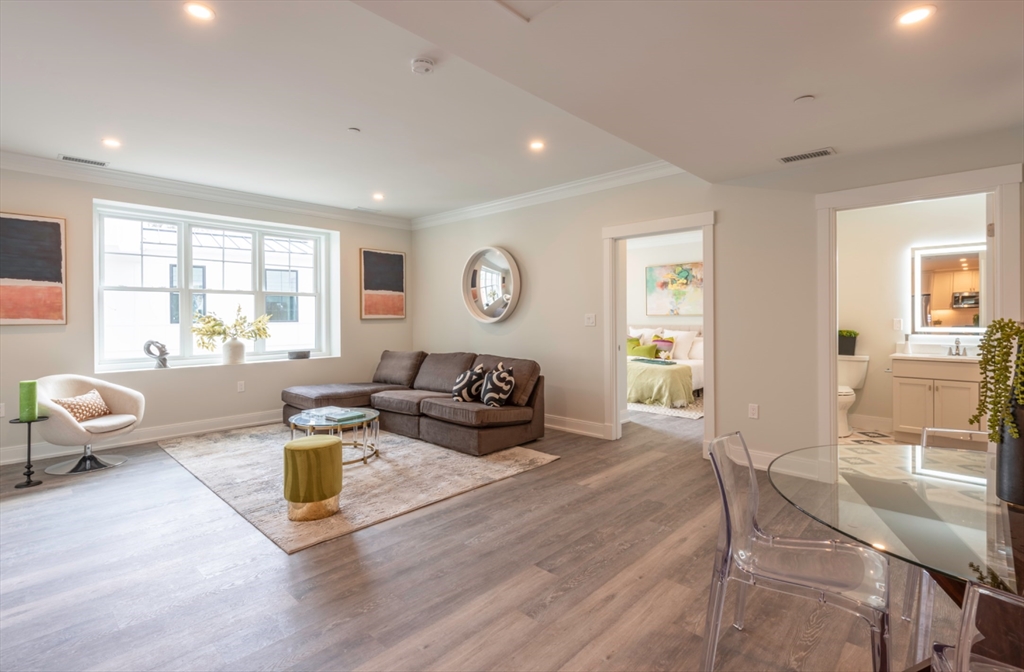 a living room with furniture and wooden floor