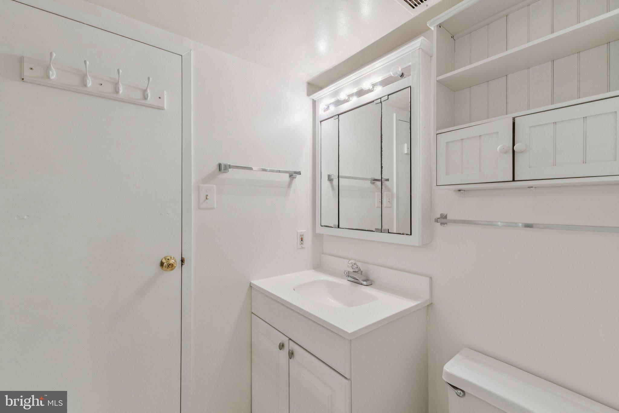2817 Jermantown Road, Unit 108 Oakton, VA 22124 - Photo 16 of 20 a bathroom with a sink a toilet and shower