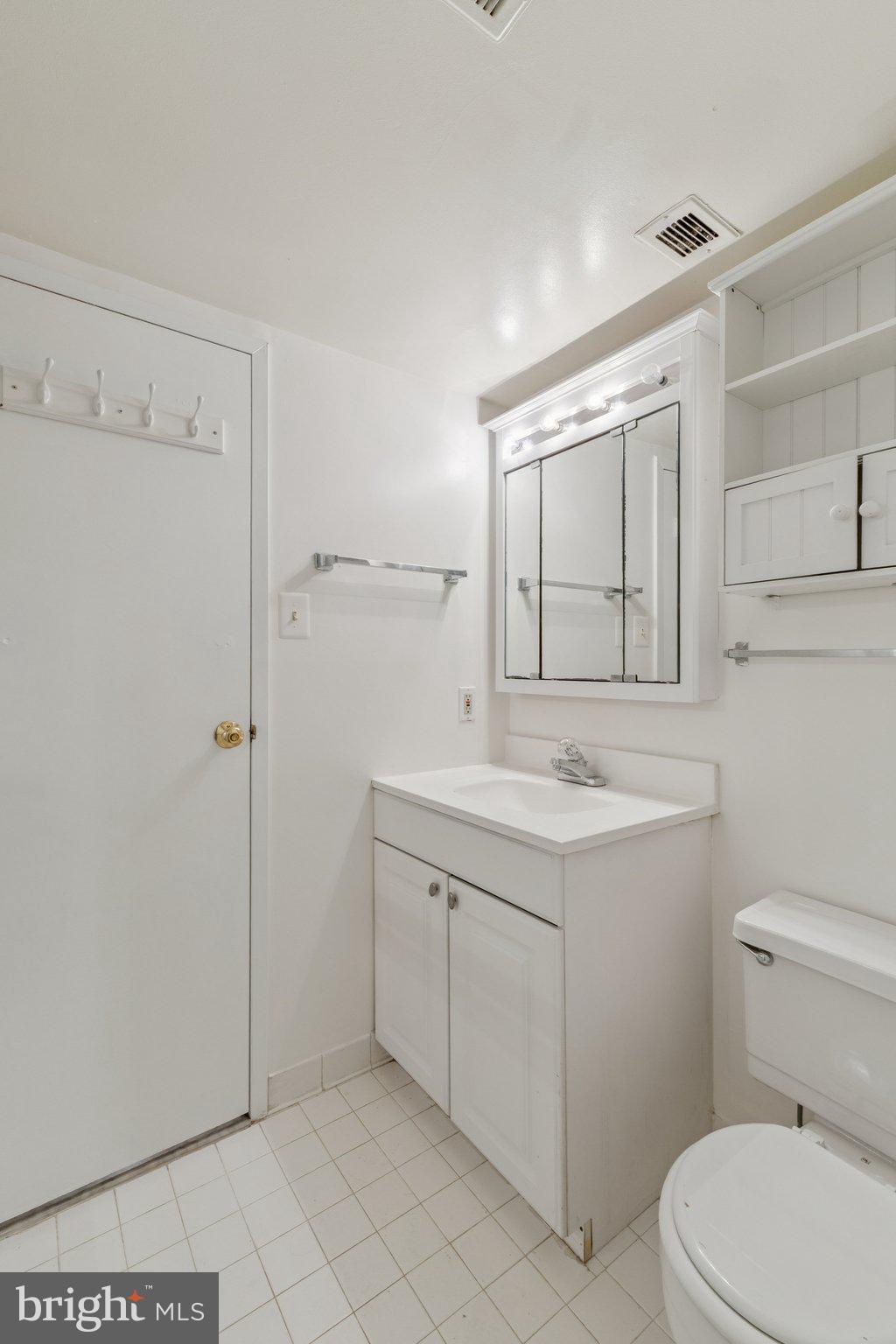 2817 Jermantown Road, Unit 108 Oakton, VA 22124 - Photo 17 of 20 a bathroom with a sink toilet and vanity