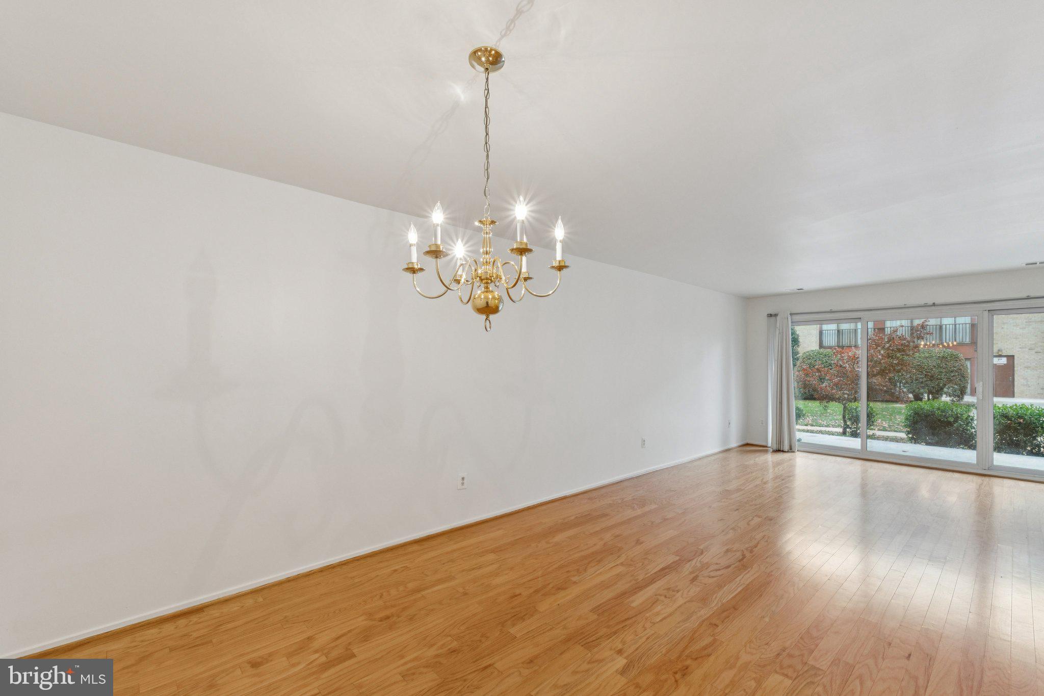 2817 Jermantown Road, Unit 108 Oakton, VA 22124 - Photo 4 of 20 a view of a room with wooden floor chandelier and mountain view