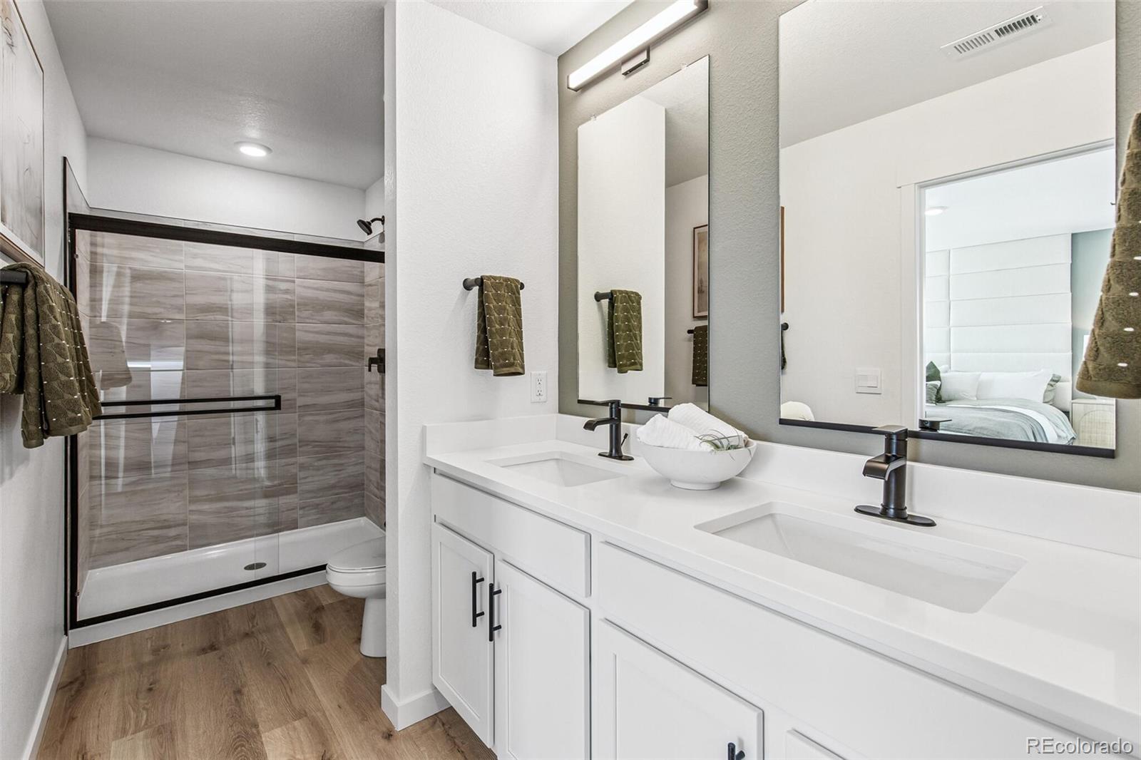 1341 South Chester Street, Unit A Denver, CO 80247 - Photo 11 of 17 a bathroom with a double vanity sink and a mirror