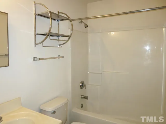 a bathroom with a shower and a toilet