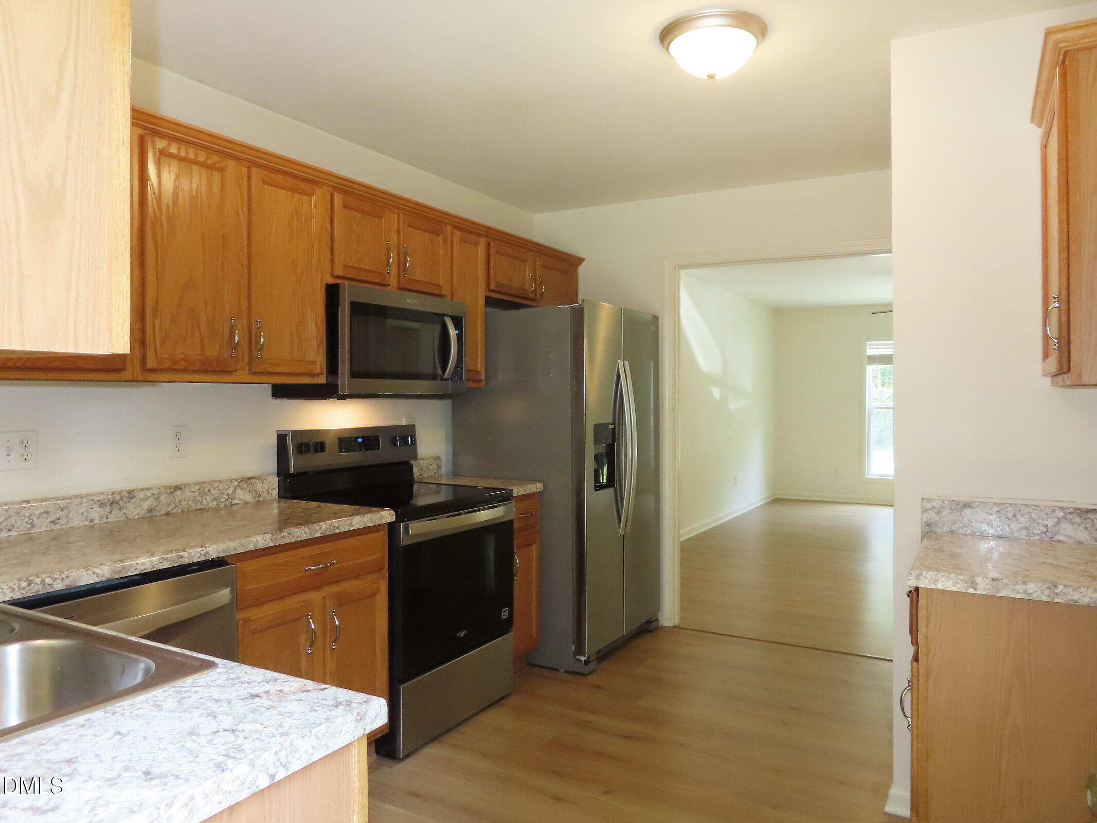314 Davie Road, Unit A Carrboro, NC 27510 - Photo 8 of 17 a kitchen with stainless steel appliances granite countertop a refrigerator stove and sink
