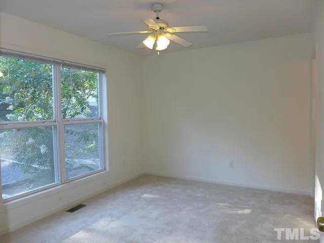a view of room with window and ceiling fan