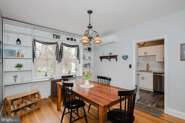 a dining room with wooden floor and breakfast area
