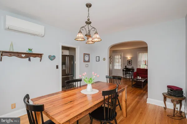 a view of a dining room with furniture wooden floor and chandelier