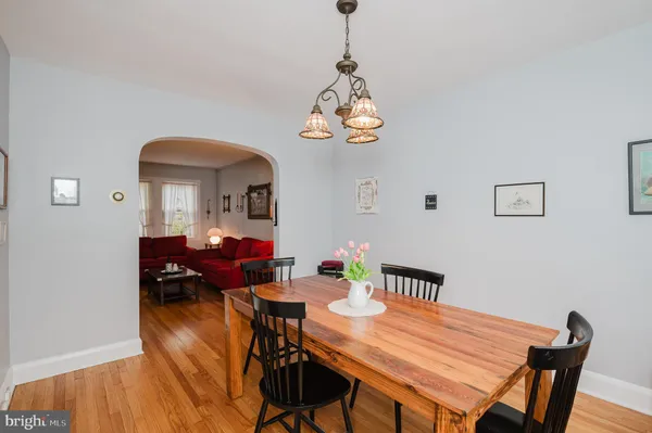 a view of a dining room with furniture wooden floor and chandelier