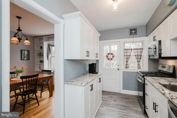 a kitchen with stainless steel appliances kitchen island granite countertop a stove a sink and a refrigerator