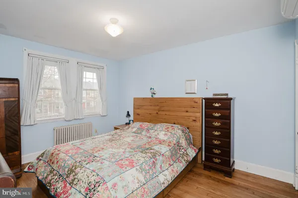 a bedroom with a bed window and chair