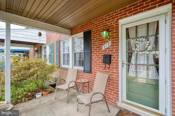 a view of a porch with a table and chairs and potted plants