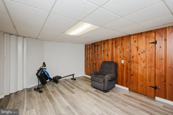 a living room with furniture a flat screen tv and piano table