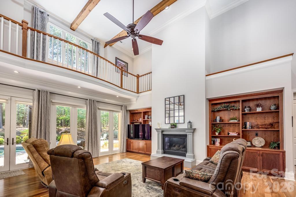 7315 Bay Ridge Drive Denver, NC 28037 - Photo 33 of 39 a living room with furniture a fireplace and a large window