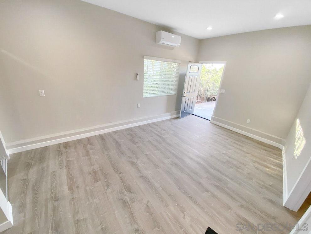 6497 Montezuma Road San Diego, CA 92115 - Photo 16 of 23 an empty room with wooden floor and windows