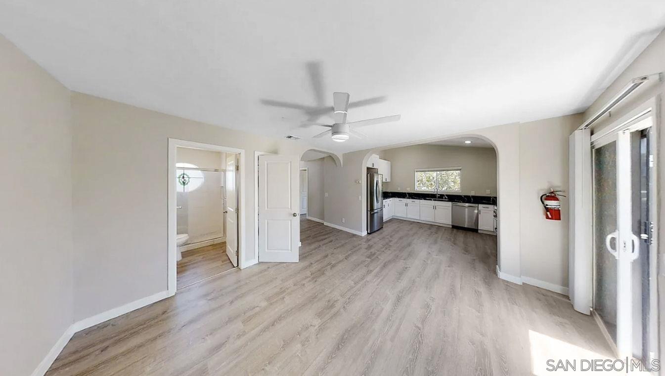 6497 Montezuma Road San Diego, CA 92115 - Photo 7 of 23 wooden floor in an empty room with a window