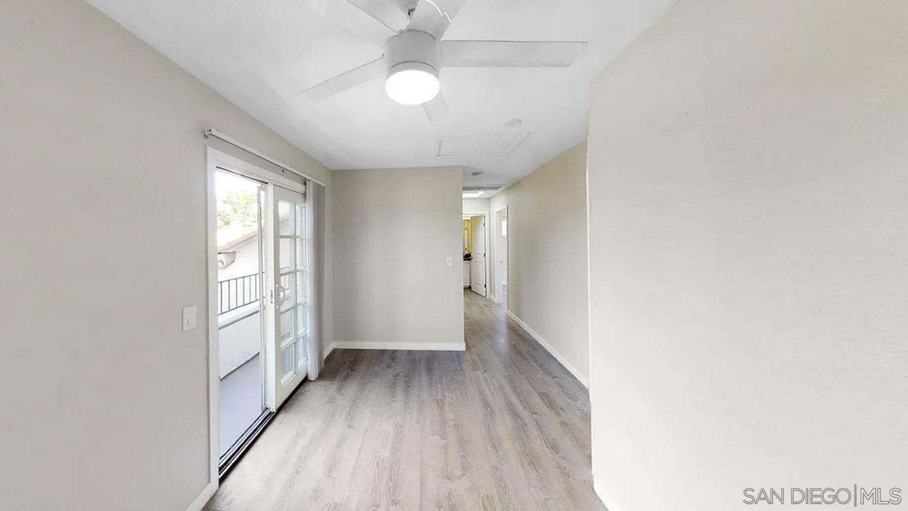 6497 Montezuma Road San Diego, CA 92115 - Photo 9 of 23 an empty room with wooden floor fan and windows