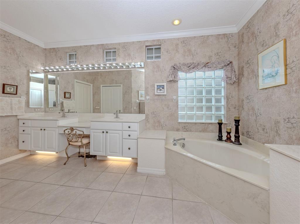 338 St George Court, Unit 11 Venice, FL 34293 - Photo 22 of 79 a bathroom with a tub sink and mirror
