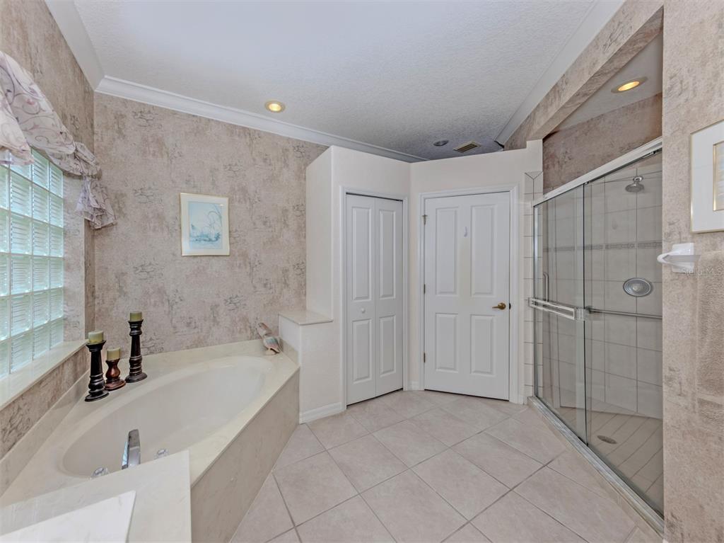 338 St George Court, Unit 11 Venice, FL 34293 - Photo 23 of 79 a spacious bathroom with a tub shower and sink