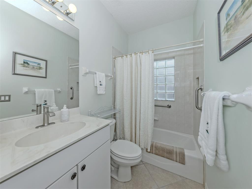 338 St George Court, Unit 11 Venice, FL 34293 - Photo 25 of 79 a bathroom with a sink toilet and shower