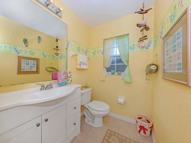 338 St George Court, Unit 11 Venice, FL 34293 - Photo 26 of 79 a bathroom with a sink mirror vanity and toilet