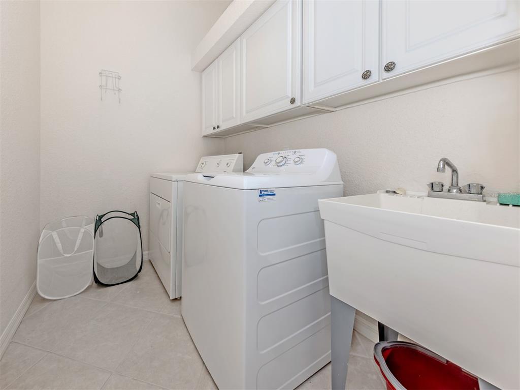 338 St George Court, Unit 11 Venice, FL 34293 - Photo 27 of 79 a utility room with dryer and washer