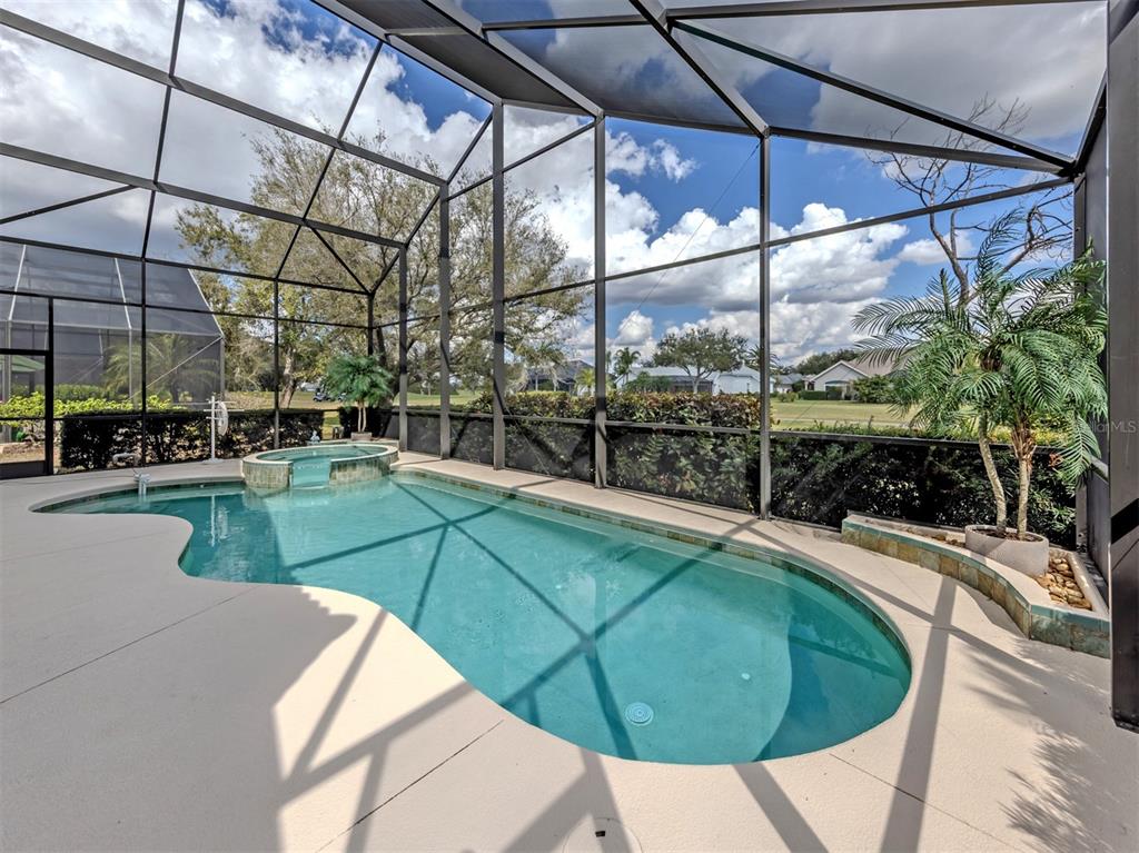 338 St George Court, Unit 11 Venice, FL 34293 - Photo 4 of 79 a view of a swimming pool with a patio and yard