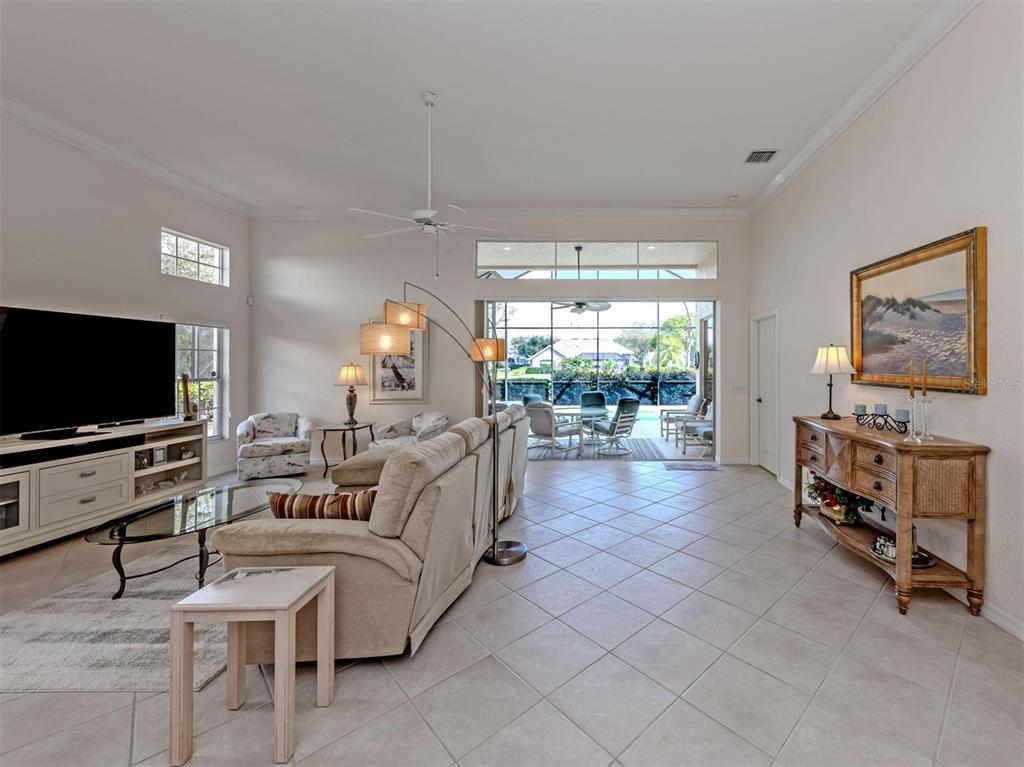 338 St George Court, Unit 11 Venice, FL 34293 - Photo 6 of 79 a living room with furniture and a flat screen tv