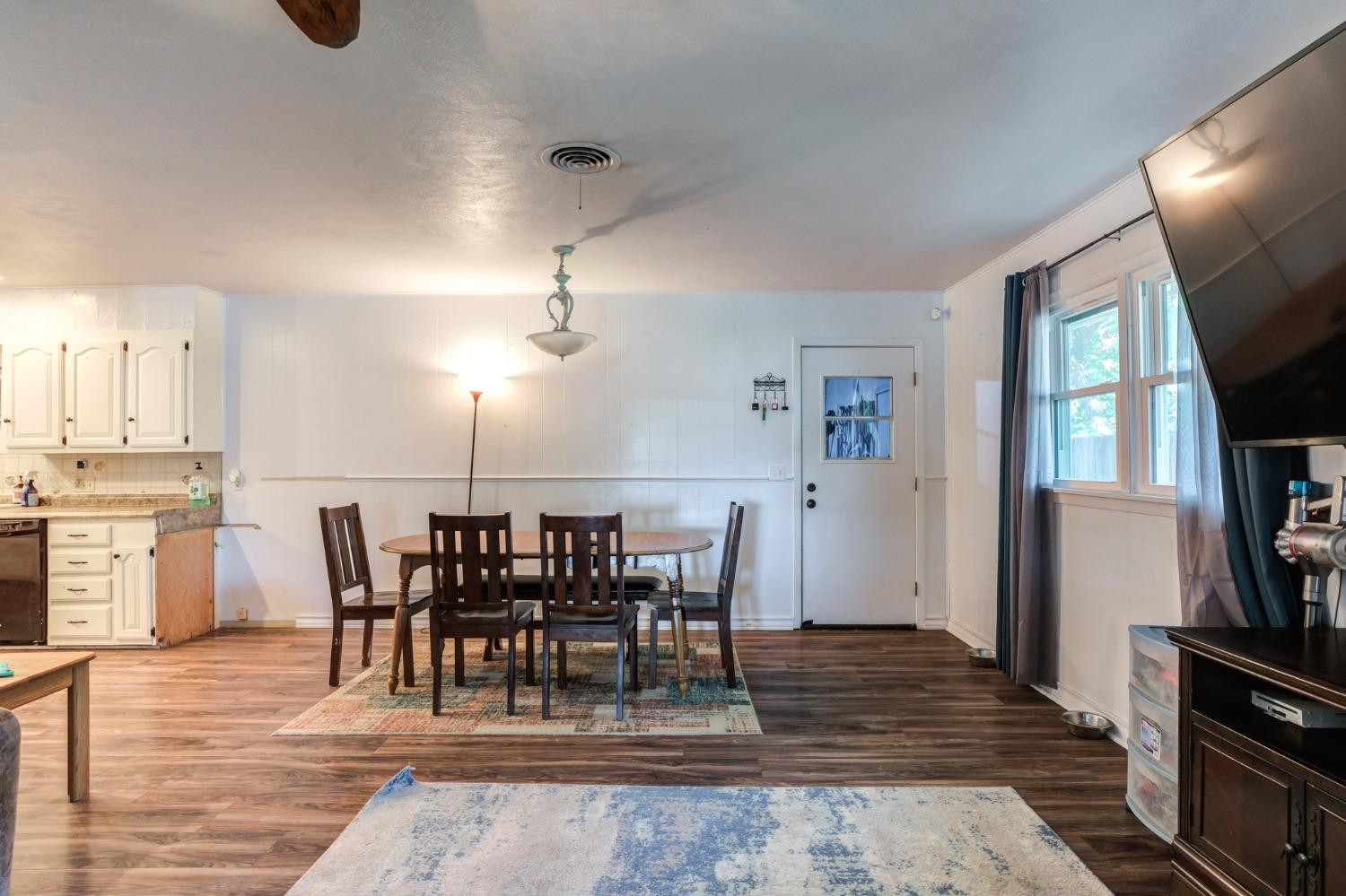334 West Ave J Muleshoe, TX 79347 - Photo 8 of 18 a view of a dining room with furniture and wooden floor