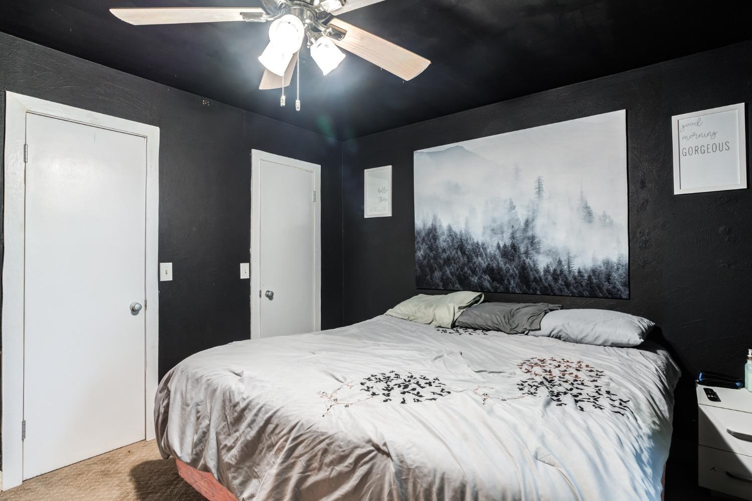 334 West Ave J Muleshoe, TX 79347 - Photo 9 of 18 a bedroom with a bed and a chandelier