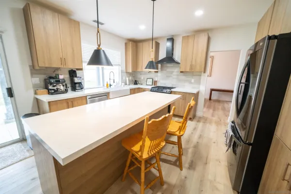a kitchen with stainless steel appliances a stove a sink a refrigerator and cabinets
