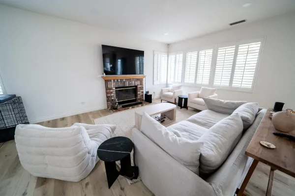a living room with furniture a fireplace and a flat screen tv