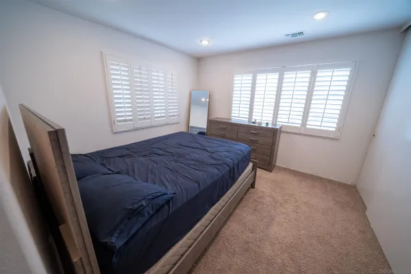 a bed sitting in a room next to a window